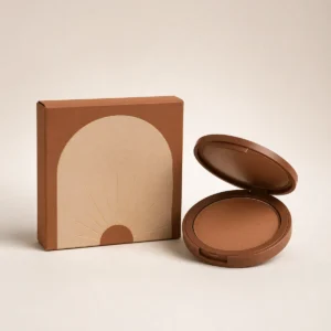 Custom bronzer box with matching product in a square studio photograph